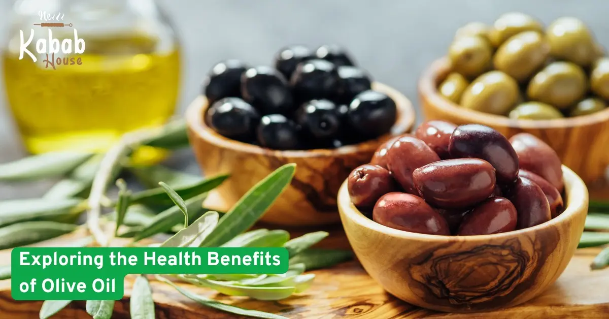 Bowls of black, green, and red olives with fresh olive leaves and olive oil bottle, highlighting the health benefits of olive oil.